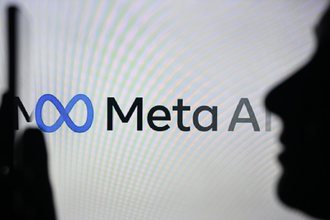 EDMONTON, CANADA - APRIL 28: An image of a woman holding a cell phone in front of the Meta AI logo displayed on a computer screen, on April 29, 2024, in Edmonton, Canada. (Photo by Artur Widak/NurPhoto via Getty Images)